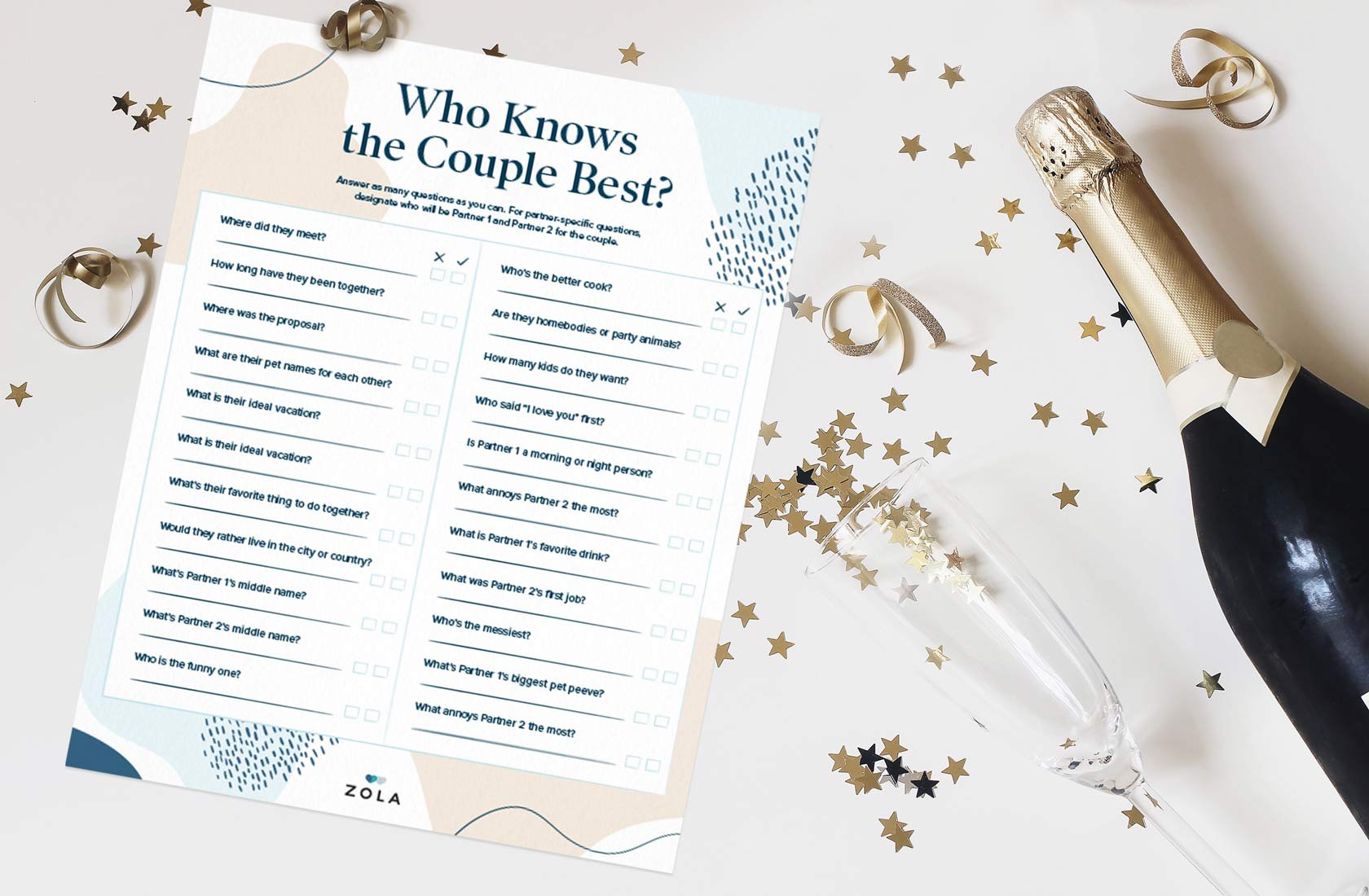 A piece of paper titled "who knows the couple best" sits on a white table with gold stars, confetti, and champagne.