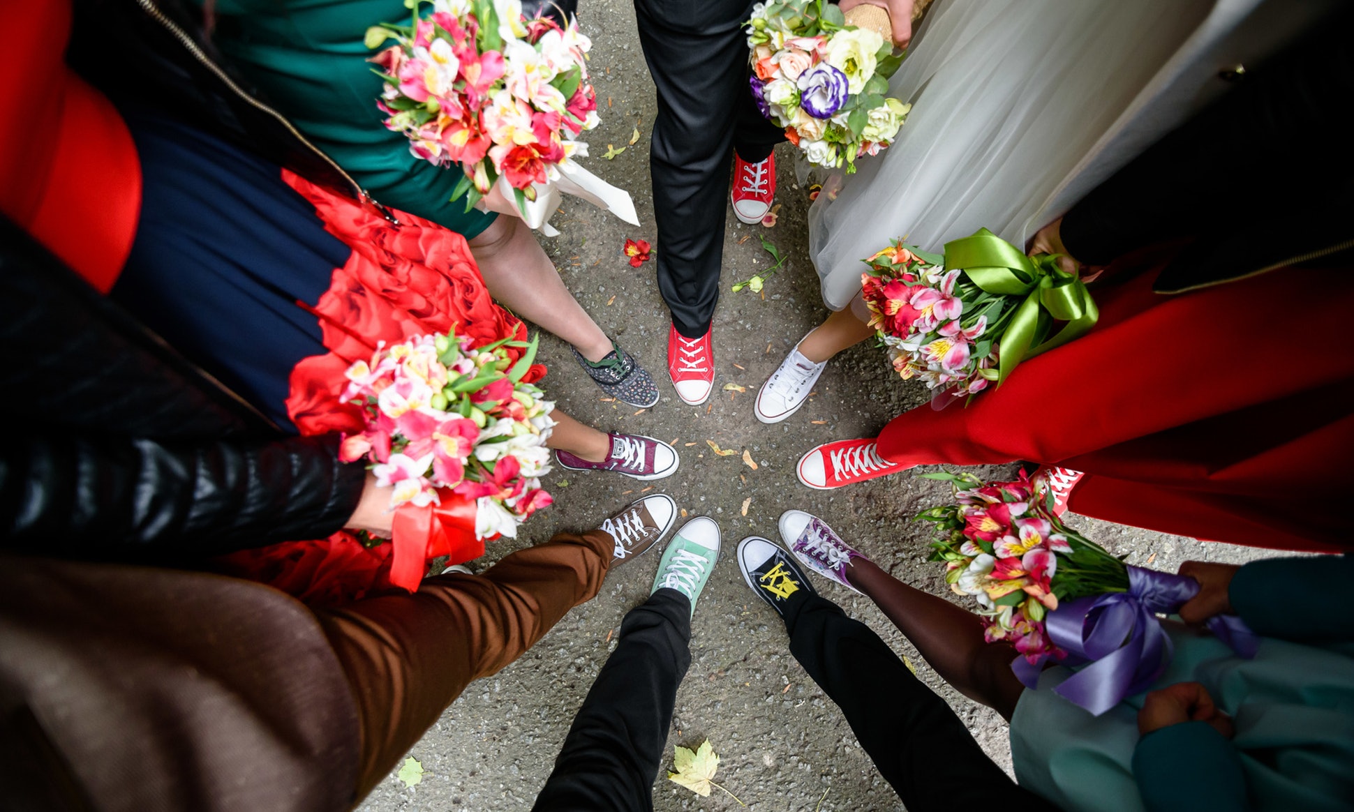 A close up photo of a circle of people putting one foot in together.