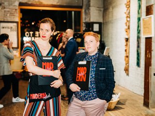 two wedding planners holding clipboards