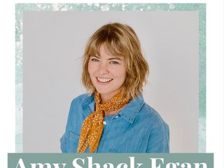 A white woman with short brown hair smiles at the camera