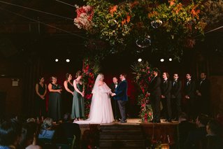 wedding ceremony on stage at an indoor venue
