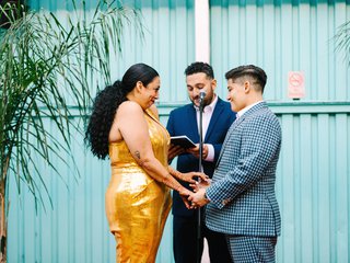 Two marriers stand at the altar, holding hands.