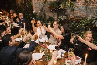 people cheersing at a wedding dinner