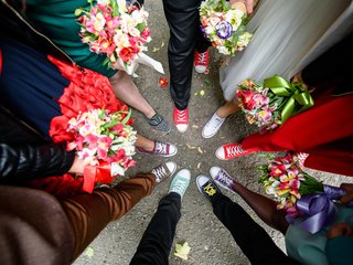 A photo of many different feet in various shoes in a circle