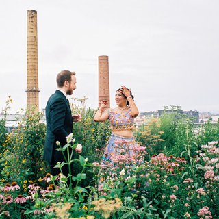 two people wandering through field of flowers