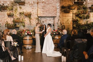 two women stand at the altar getting married