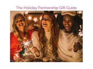 Three women in sweaters hold sparklers under the text, 'holiday partnership gift guide'